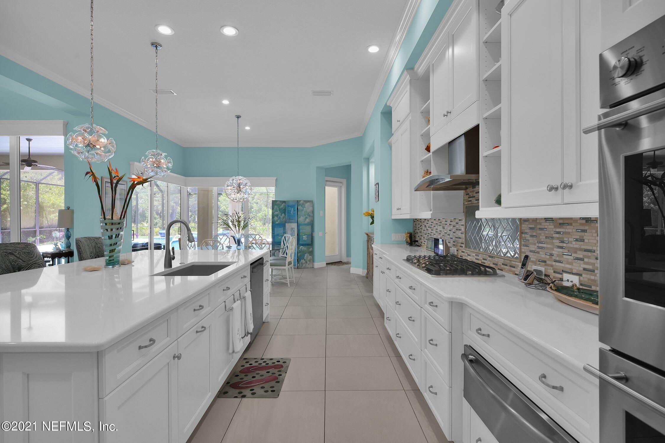 496 Costa Del Sol Drive St. Augustine, FL 32095 - Photo 33 of 111 a large white kitchen with stainless steel appliances granite countertop lots of counter top space