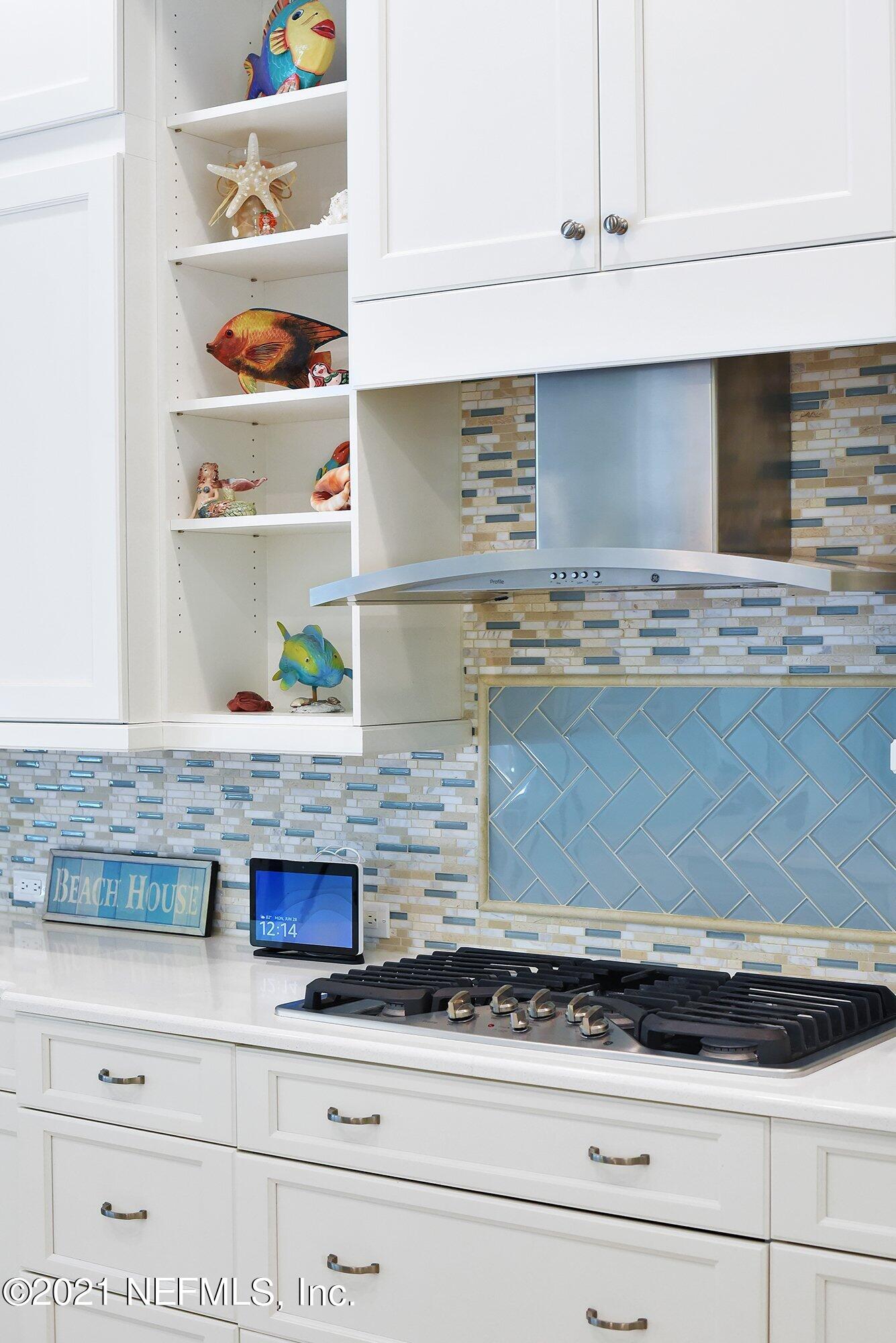 496 Costa Del Sol Drive St. Augustine, FL 32095 - Photo 34 of 111 a kitchen with white cabinets and a counter top