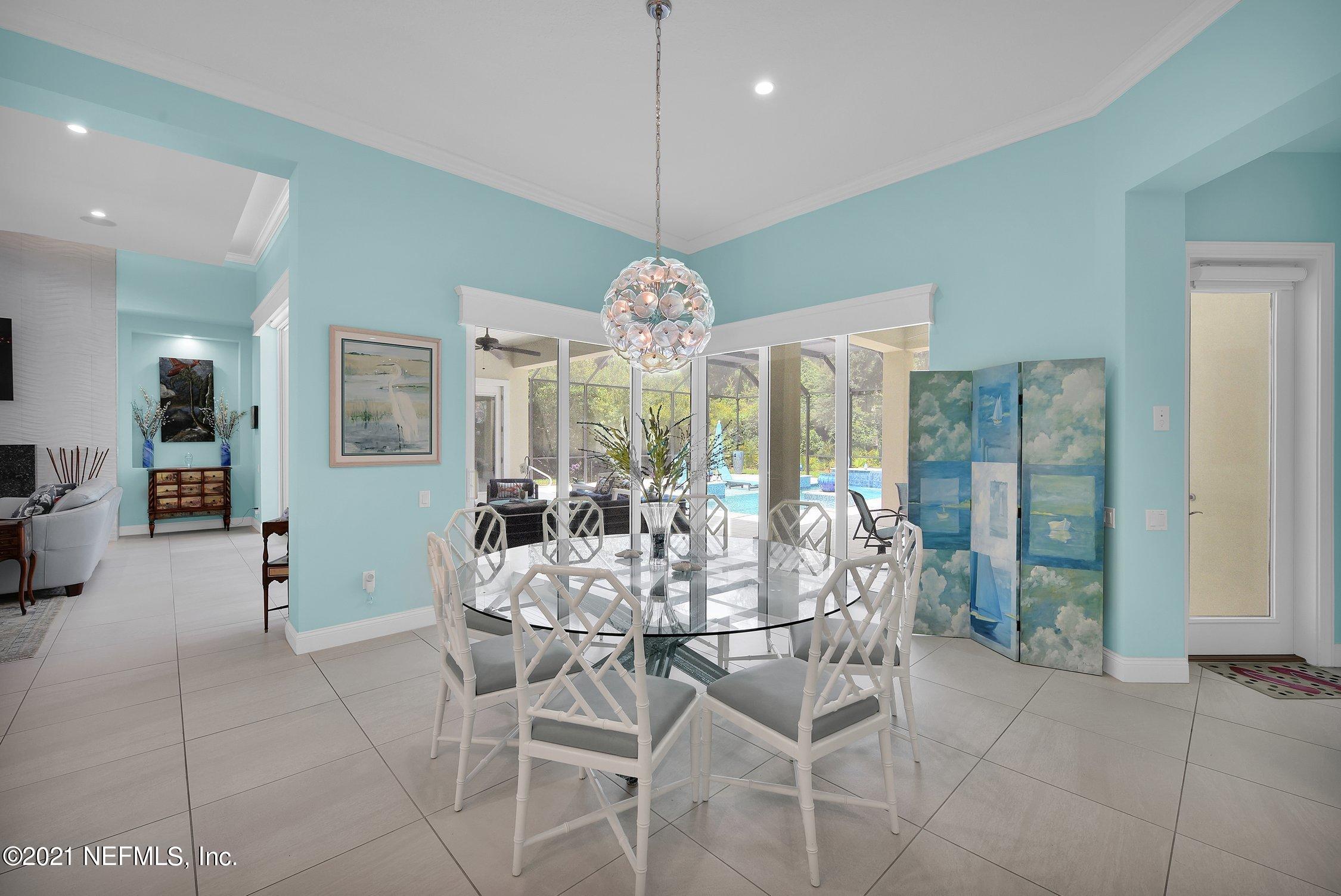 496 Costa Del Sol Drive St. Augustine, FL 32095 - Photo 36 of 111 a view of a dining room with furniture a chandelier and wooden floor