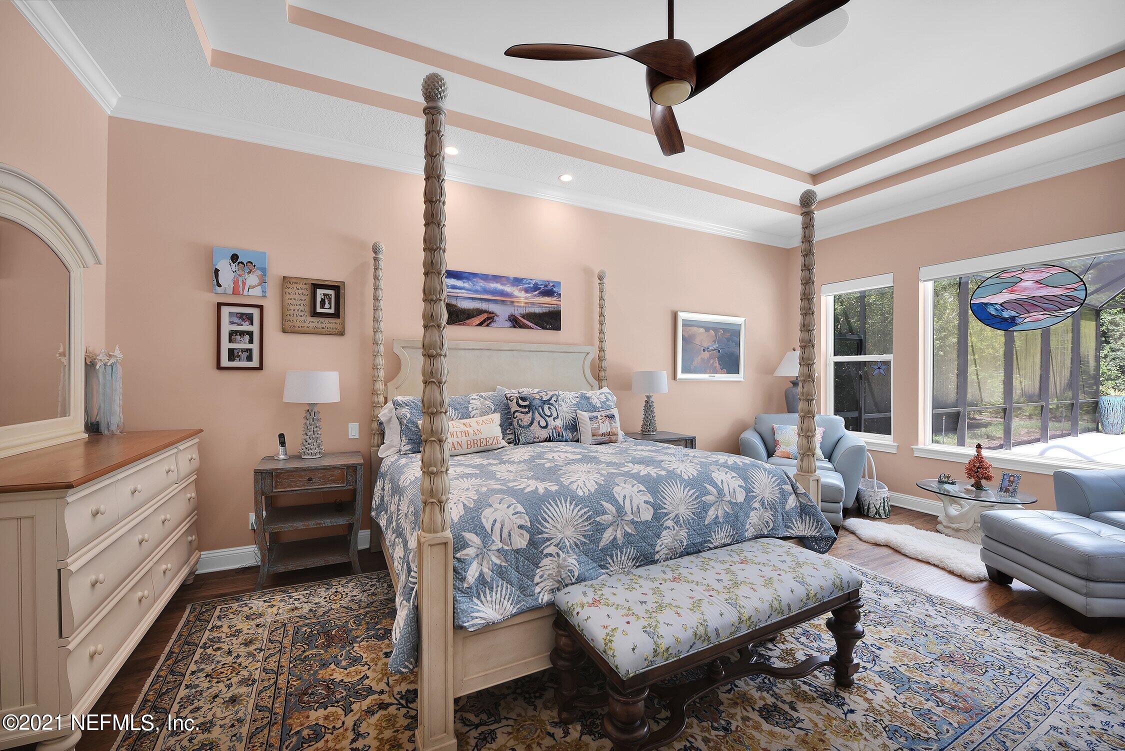 496 Costa Del Sol Drive St. Augustine, FL 32095 - Photo 43 of 111 a spacious bedroom with a bed a couch and a window