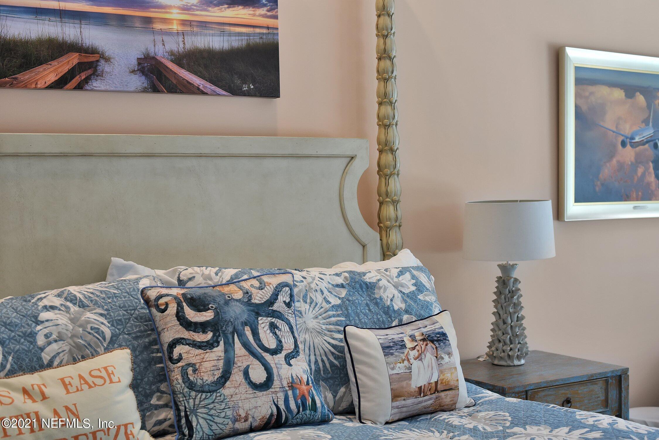 496 Costa Del Sol Drive St. Augustine, FL 32095 - Photo 44 of 111 a bedroom with a bed and a painting on the wall