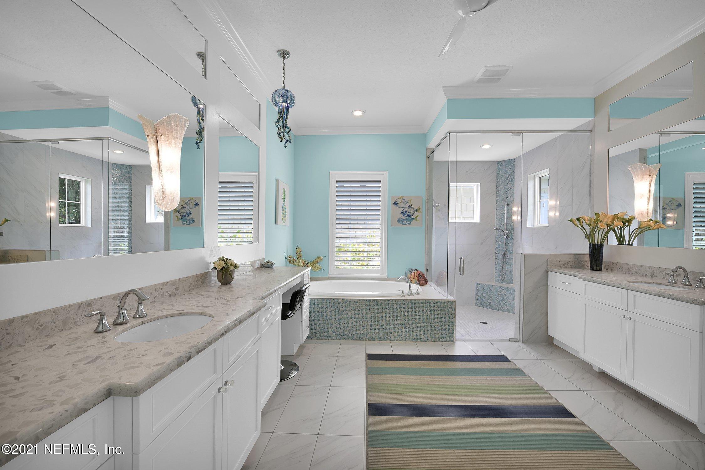 496 Costa Del Sol Drive St. Augustine, FL 32095 - Photo 48 of 111 a spacious bathroom with a granite countertop sink mirror and a bathtub