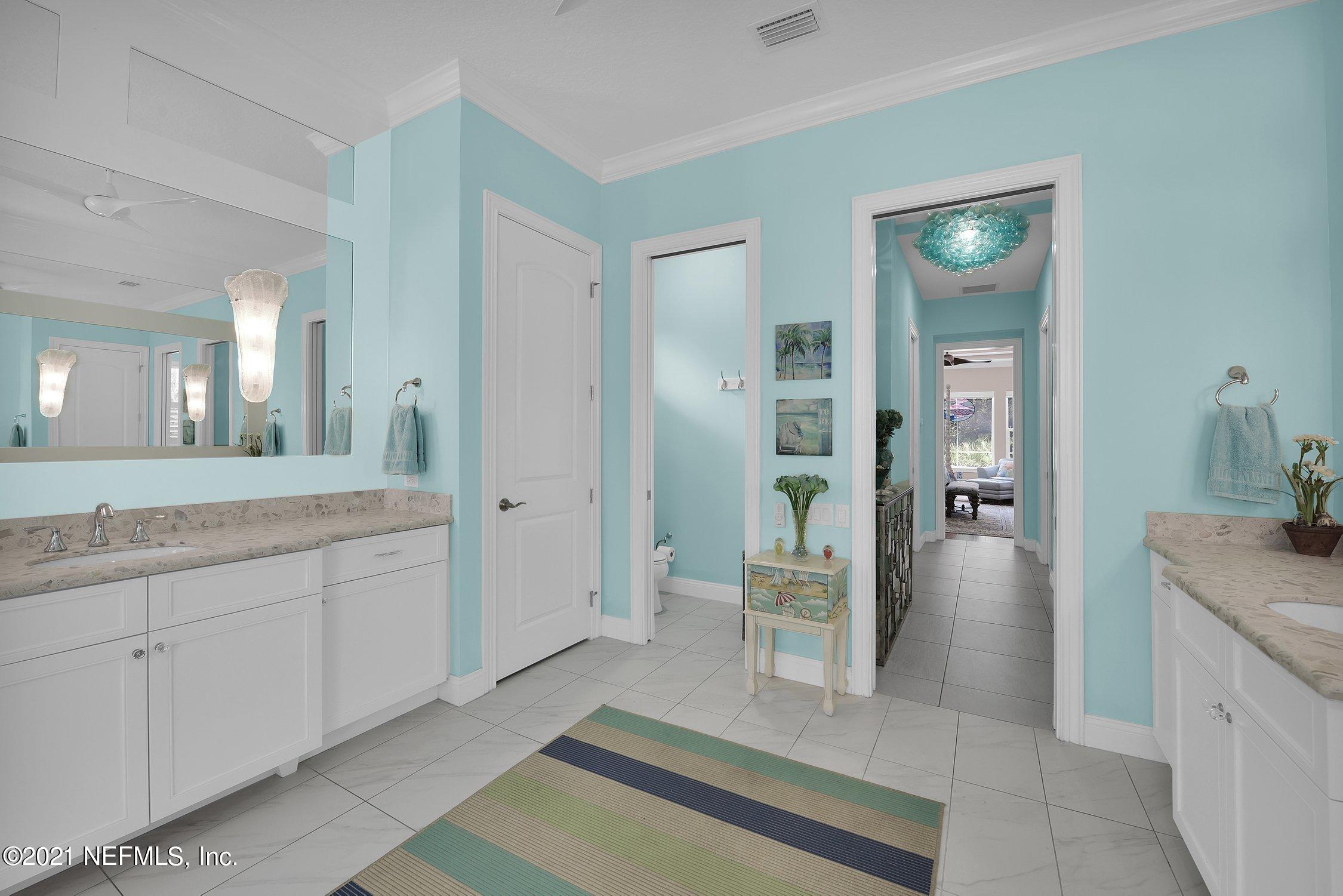 496 Costa Del Sol Drive St. Augustine, FL 32095 - Photo 55 of 111 a spacious bathroom with a granite countertop sink and mirror