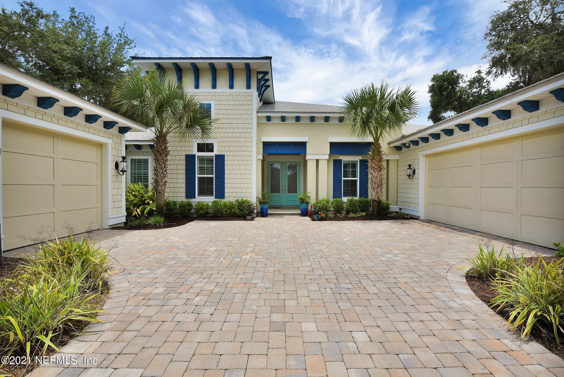 496 Costa Del Sol Drive St. Augustine, FL 32095 - Photo 6 of 111 a front view of a house with a yard and potted plants