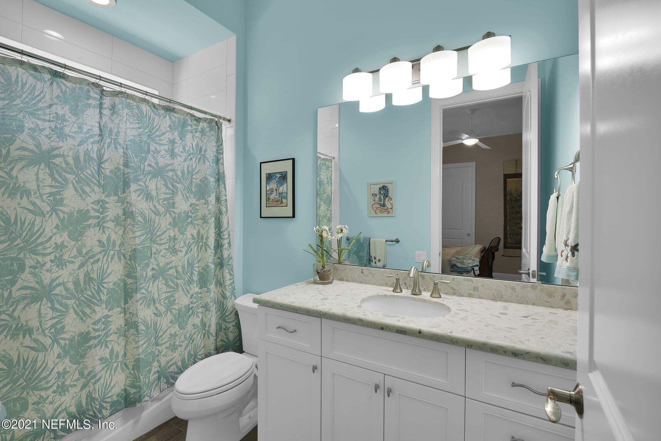 496 Costa Del Sol Drive St. Augustine, FL 32095 - Photo 61 of 111 a bathroom with a granite countertop sink mirror and toilet