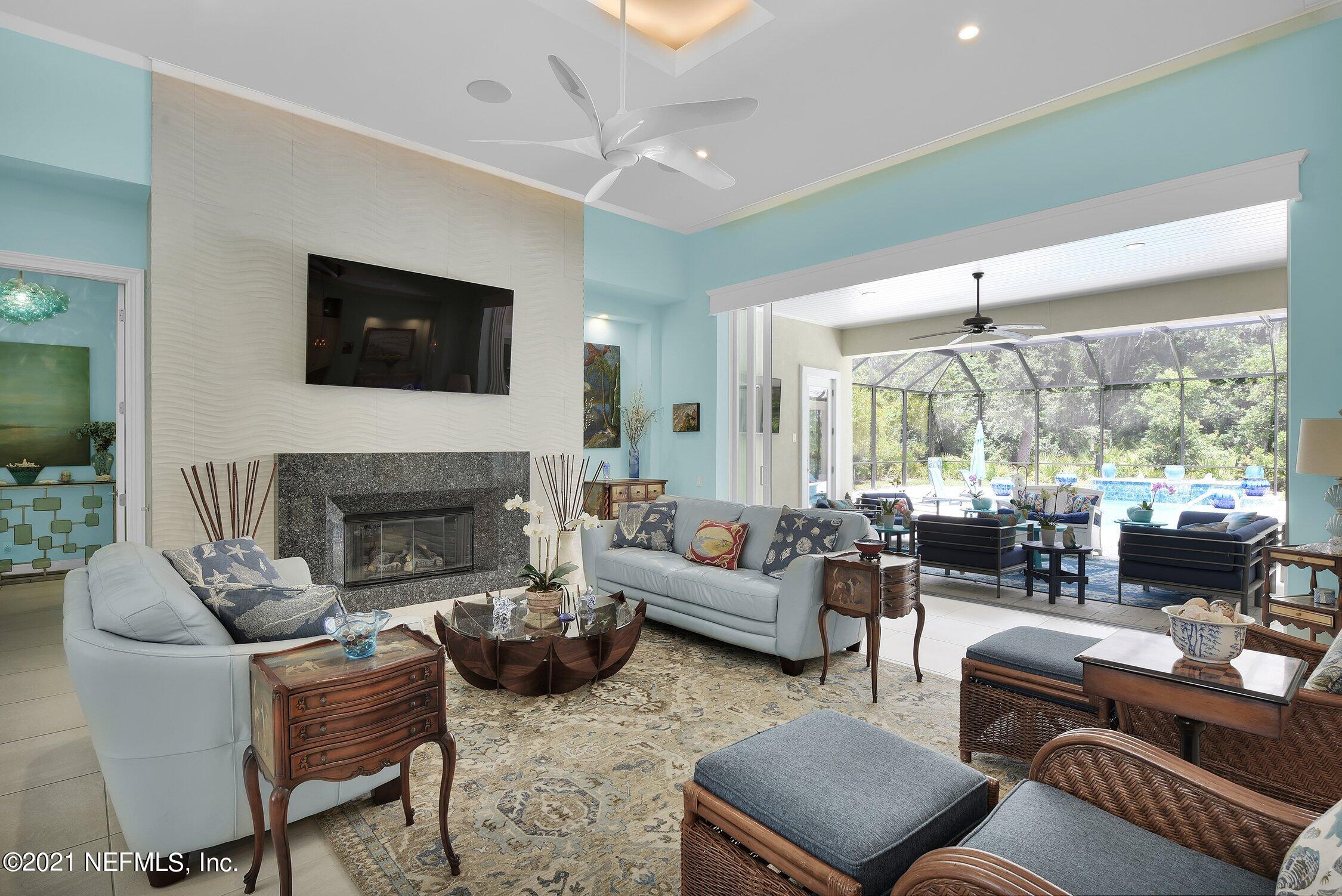 496 Costa Del Sol Drive St. Augustine, FL 32095 - Photo 75 of 111 a living room with furniture fireplace and a large window