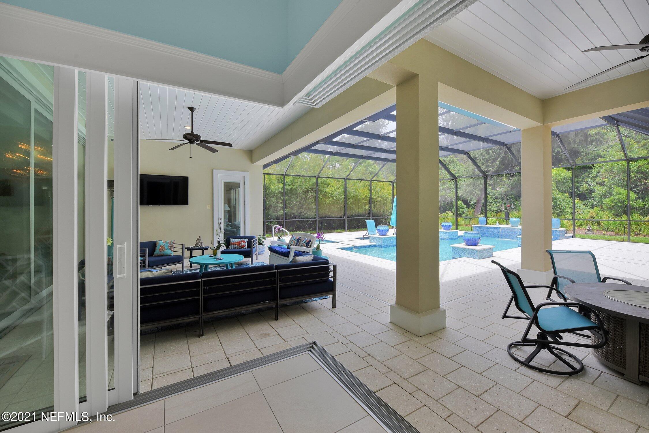 496 Costa Del Sol Drive St. Augustine, FL 32095 - Photo 78 of 111 a living room with furniture and a floor to ceiling window