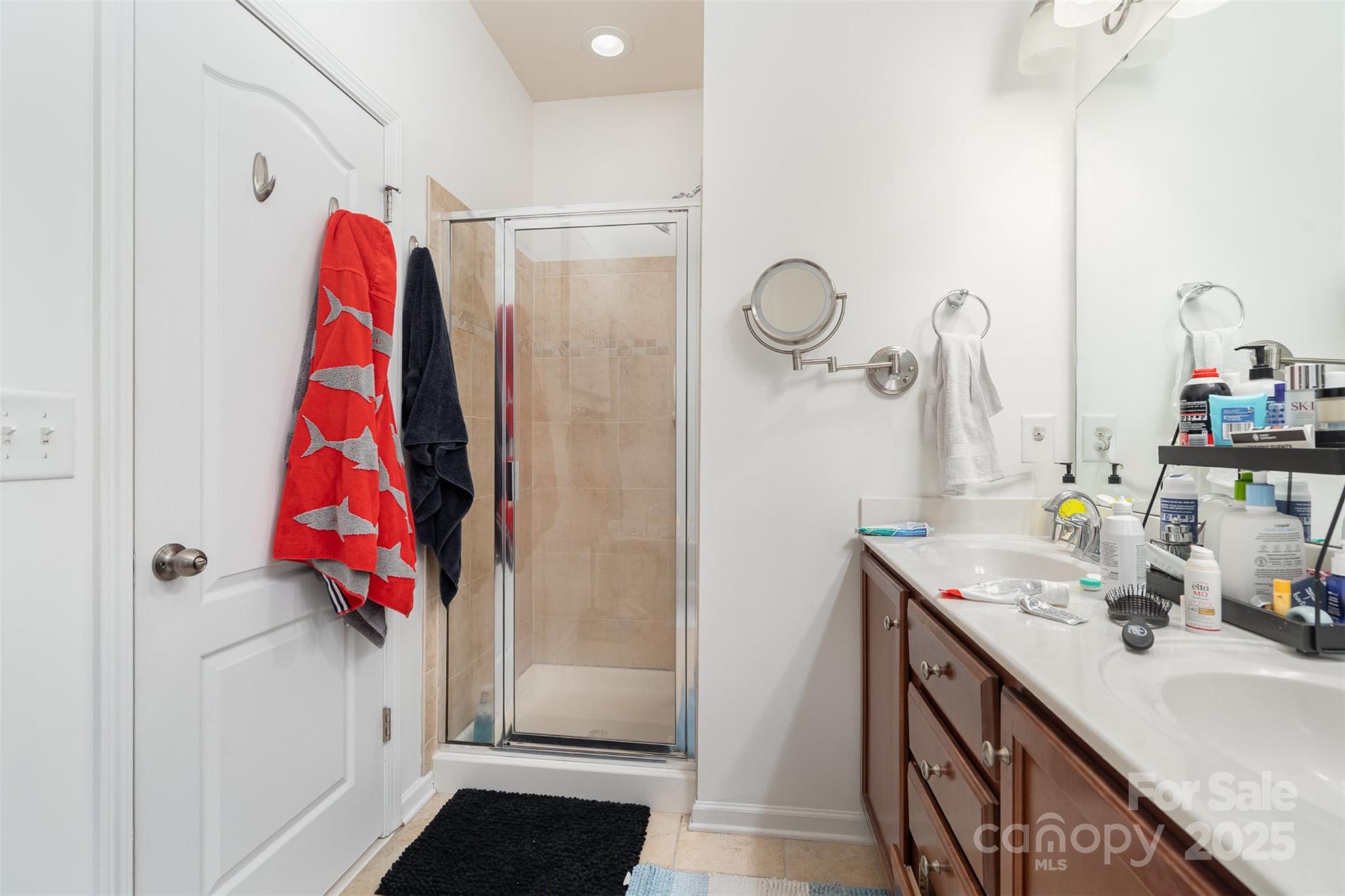 8245 Viewpoint Lane Cornelius, NC 28031 - Photo 16 of 32 a bathroom with a sink vanity and mirror