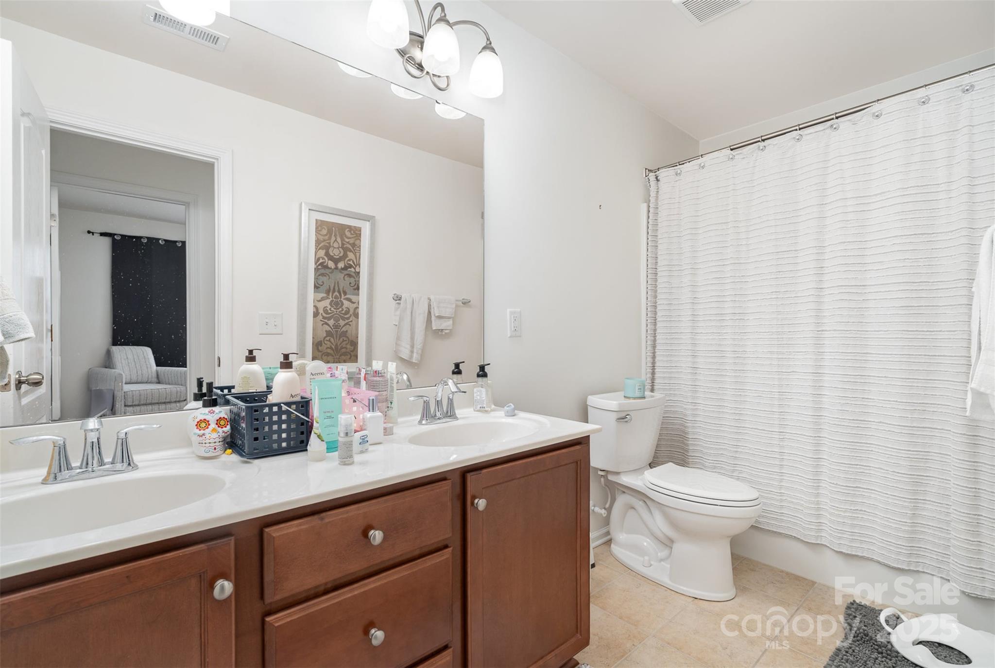 8245 Viewpoint Lane Cornelius, NC 28031 - Photo 22 of 32 a bathroom with a double vanity sink toilet and a mirror