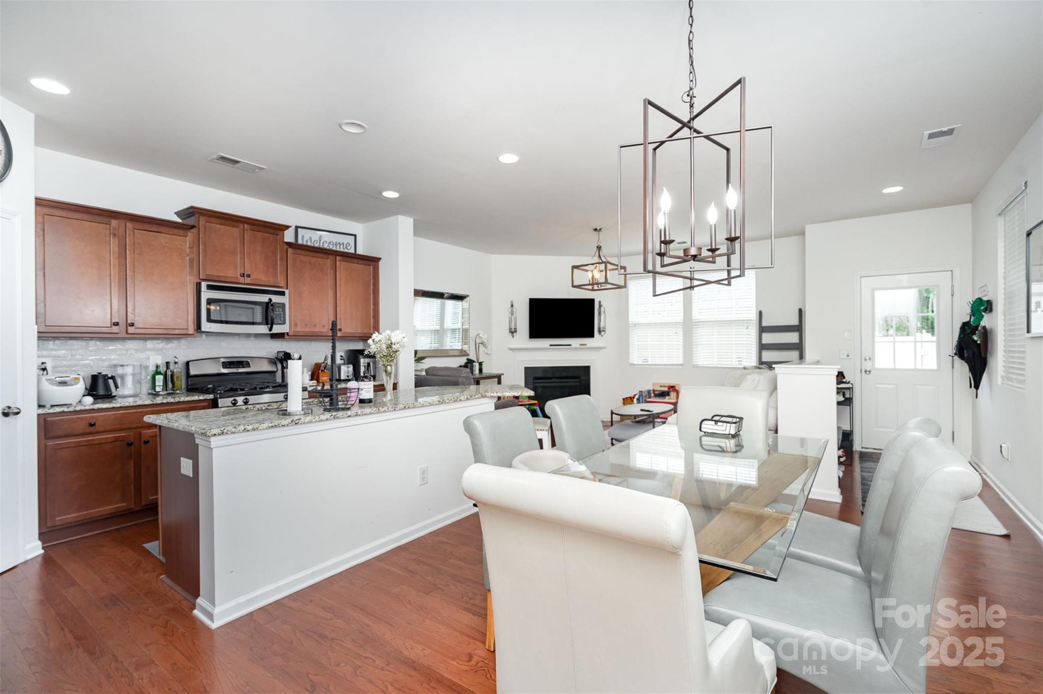 8245 Viewpoint Lane Cornelius, NC 28031 - Photo 7 of 32 a kitchen with stainless steel appliances kitchen island granite countertop a sink and cabinets