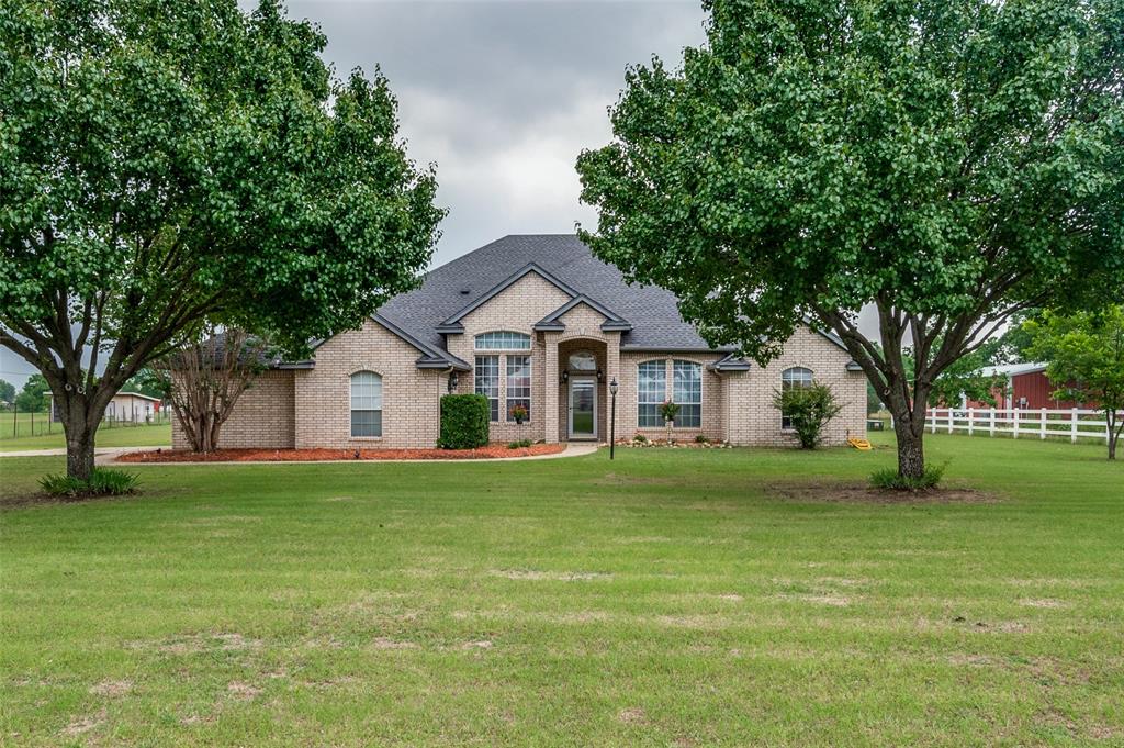 13420 Haslet Court Haslet, TX 76052 - Photo 1 of 26 a front view of a house with a yard and trees