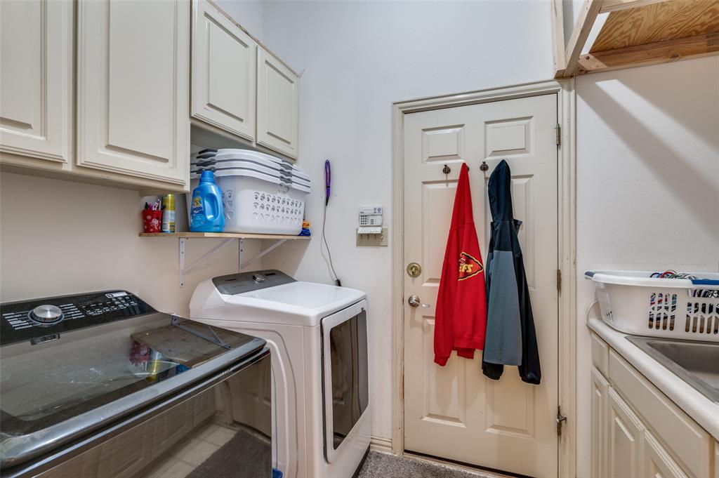 13420 Haslet Court Haslet, TX 76052 - Photo 23 of 26 a view of walk in closet with clothes and shoes