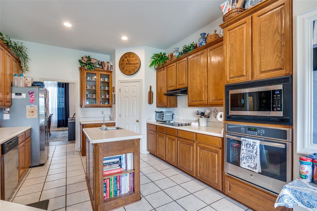 13420 Haslet Court Haslet, TX 76052 - Photo 7 of 26 a kitchen with stainless steel appliances granite countertop a stove and a sink