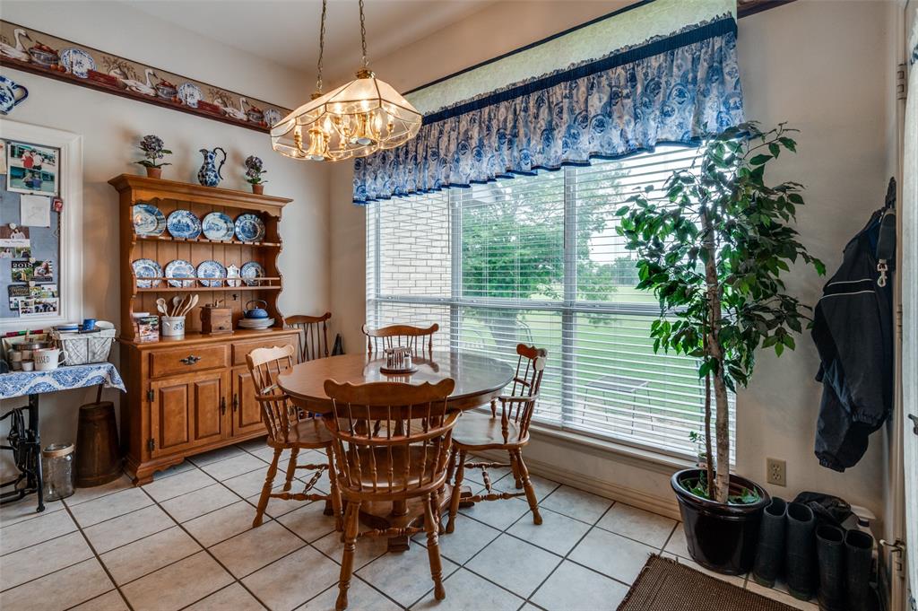 13420 Haslet Court Haslet, TX 76052 - Photo 10 of 26 a dining room with furniture a chandelier and window