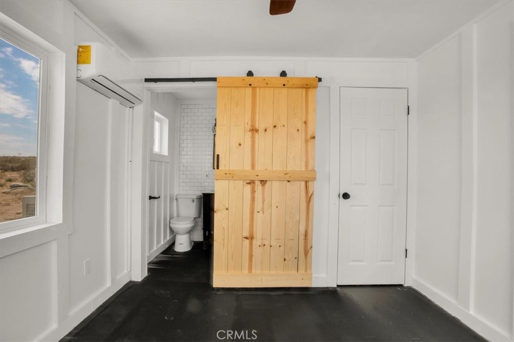 777 Quail Bush Road Landers, CA 92285 - Photo 15 of 46 a view of walk in closet with wooden floor