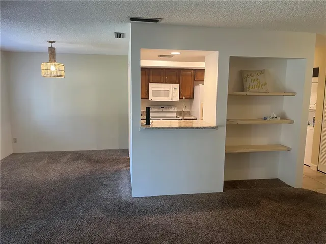 a view of a room with a cabinet and lamp