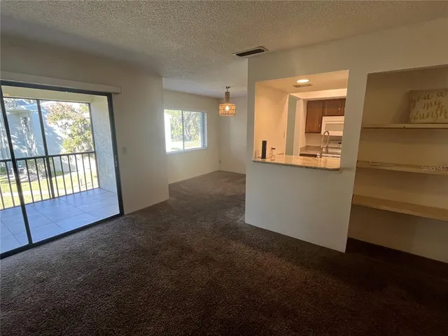 a view of a kitchen and a window in a room