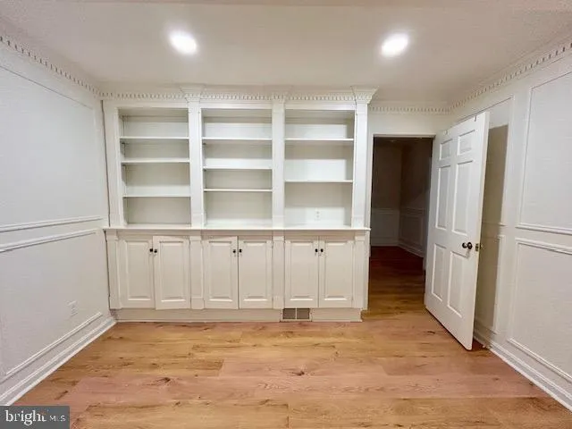 a view of an empty room with cabinet and utility room