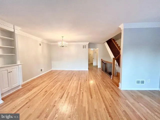 a view of a room with wooden floor and staircase