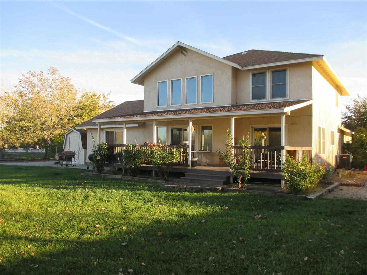 4156 Magnolia Road Fallon, NV 89406 - Photo 1 of 1 a front view of a house with a yard table and chairs