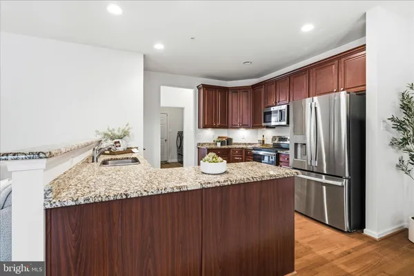 a kitchen with refrigerator and a sink