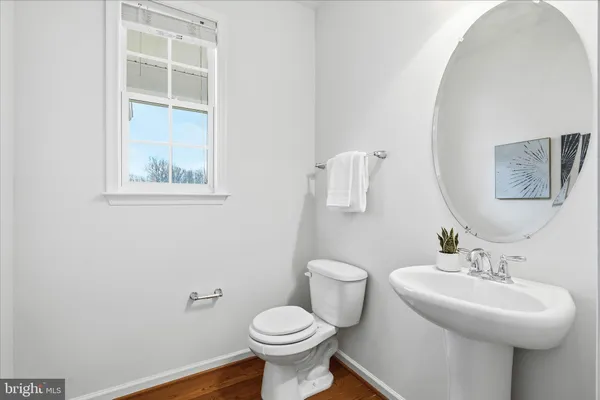 a bathroom with a sink toilet and a mirror