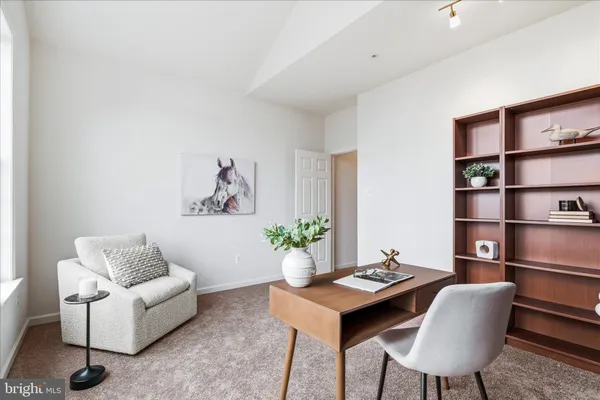 a living room with furniture and a bookshelf