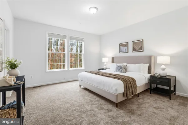 a spacious bedroom with a bed and a window