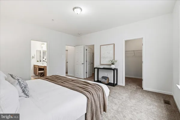 a spacious bedroom with a bed and a table