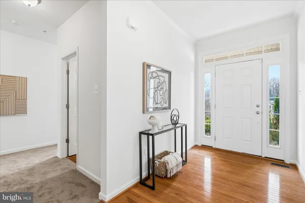 a view of a room with wooden floor windows and hallway