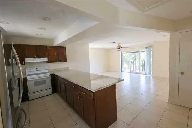 a kitchen with a cabinets counter top space appliances and a window