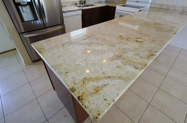 a kitchen with a sink window and stainless steel appliances