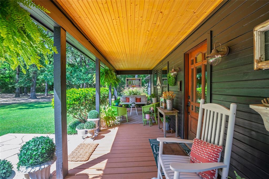 1516 Rancho Road Quinlan, TX 75474 - Photo 26 of 40 a view of a patio with a table chairs and a backyard