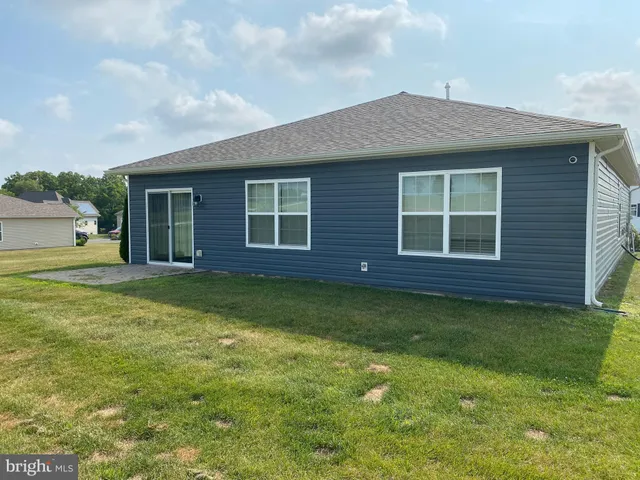 a view of a house with a backyard