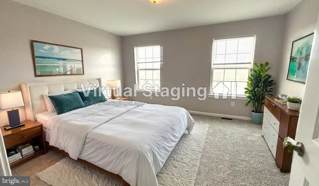 a bed sitting in a bedroom next to a window