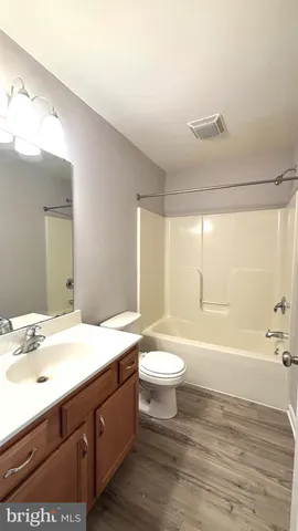 a bathroom with a sink a toilet and bathtub