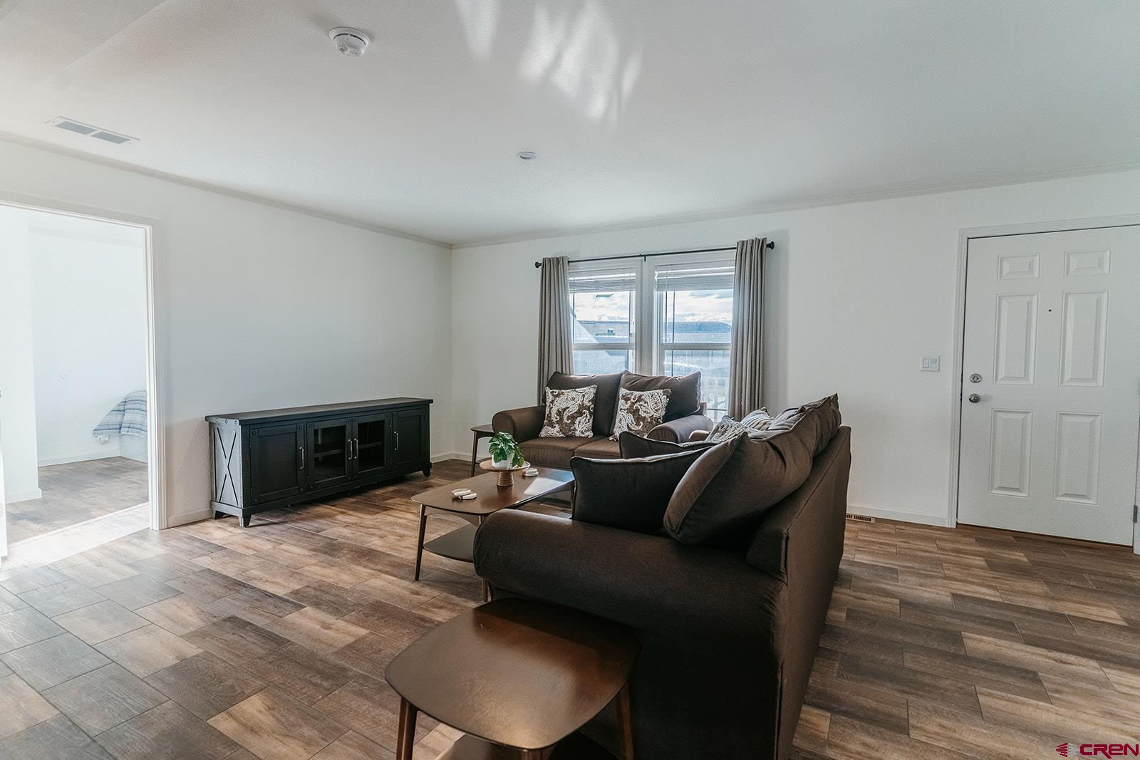 62650 Lasalle Road, Unit 820 Montrose, CO 81403 - Photo 11 of 29 a living room with furniture a fireplace and a wooden floor
