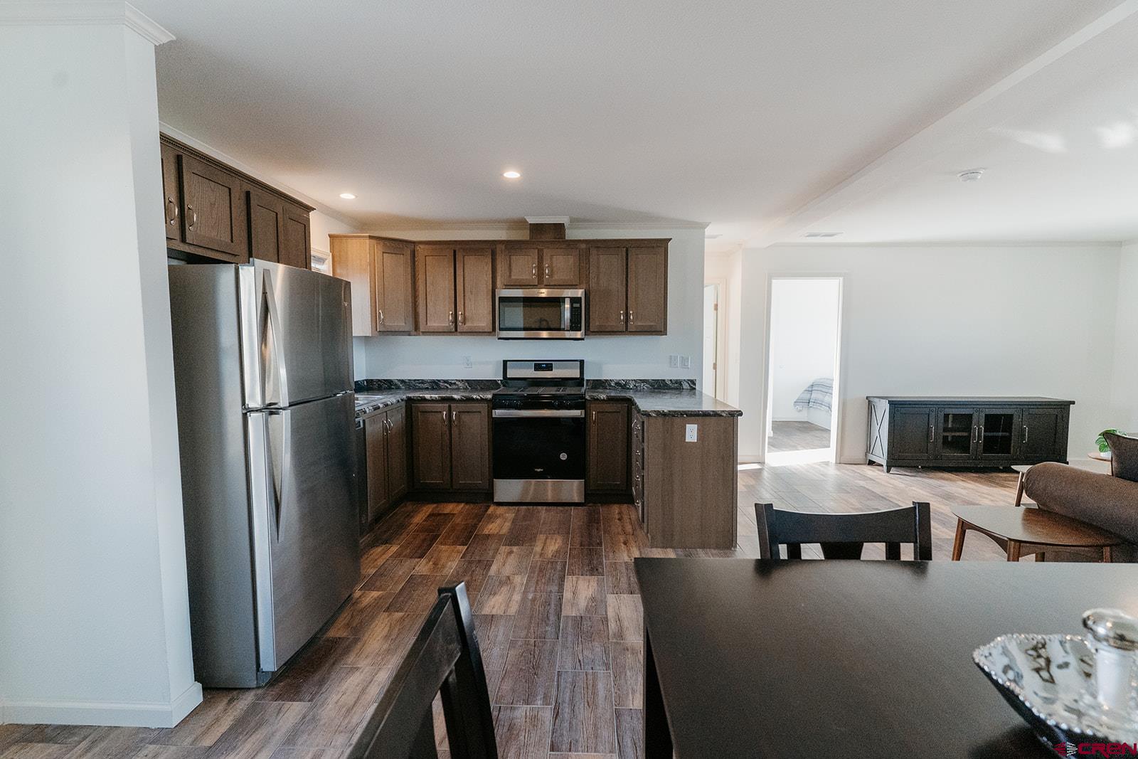 62650 Lasalle Road, Unit 820 Montrose, CO 81403 - Photo 17 of 29 a kitchen with stainless steel appliances granite countertop a refrigerator and a stove top oven
