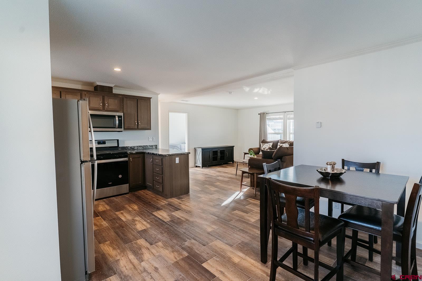62650 Lasalle Road, Unit 820 Montrose, CO 81403 - Photo 18 of 29 a kitchen with a table and chairs in it