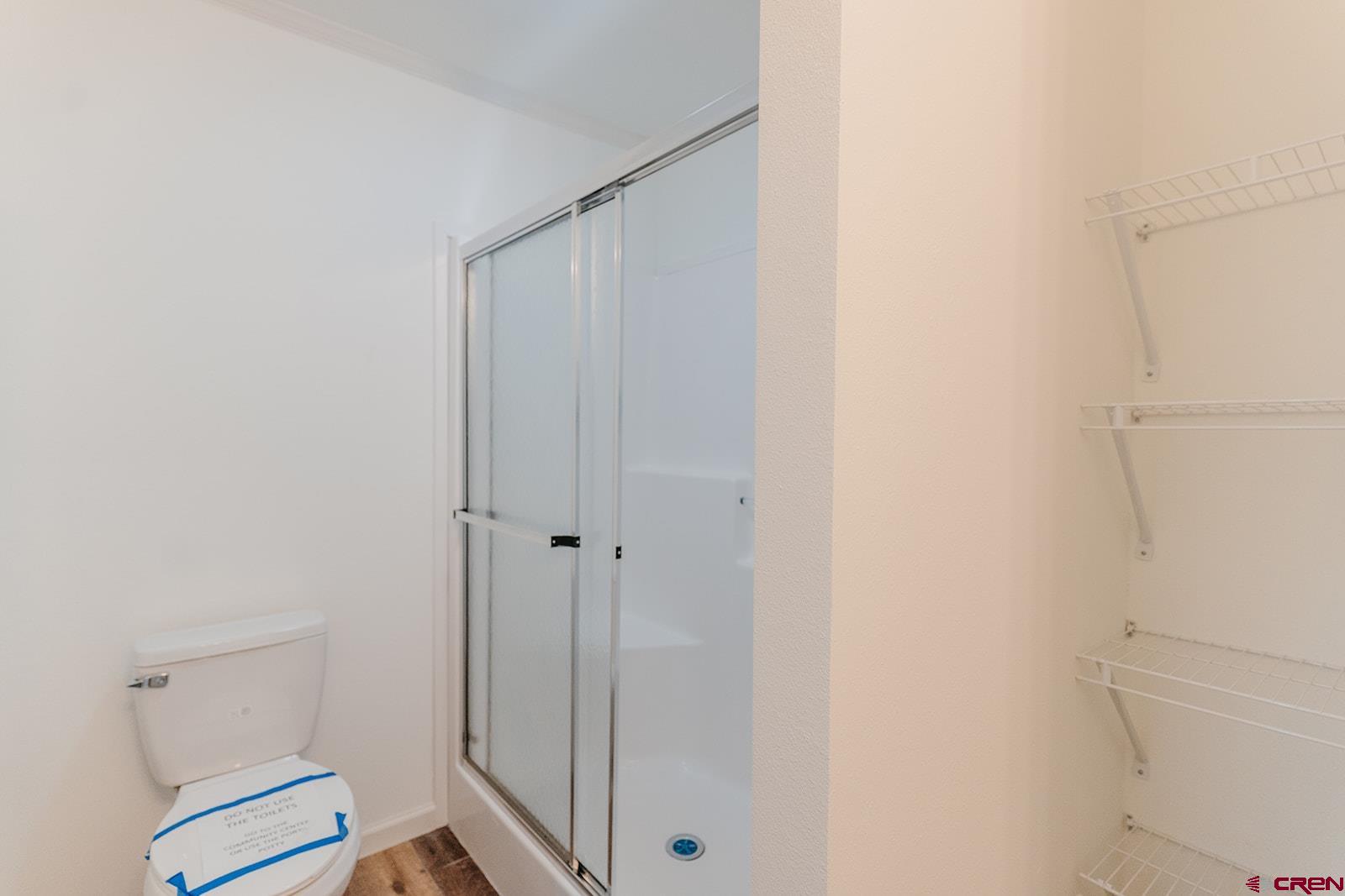 62650 Lasalle Road, Unit 820 Montrose, CO 81403 - Photo 22 of 29 a bathroom with a shower and a toilet