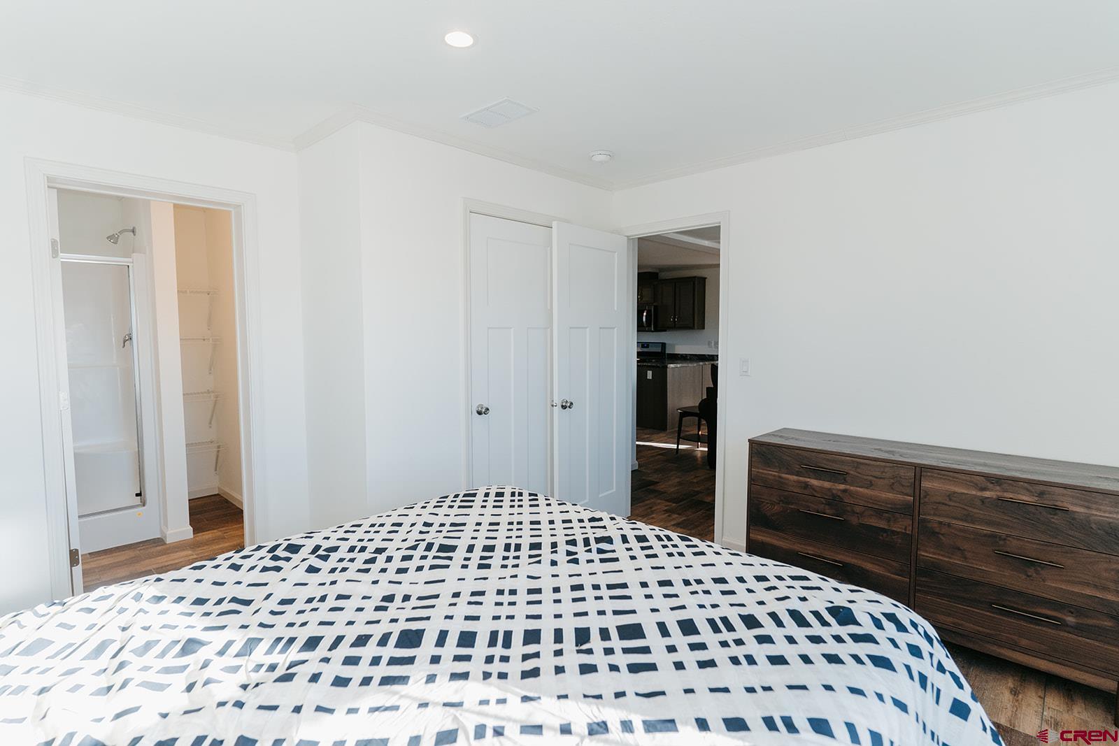 62650 Lasalle Road, Unit 820 Montrose, CO 81403 - Photo 23 of 29 a bedroom with a bed and cabinets
