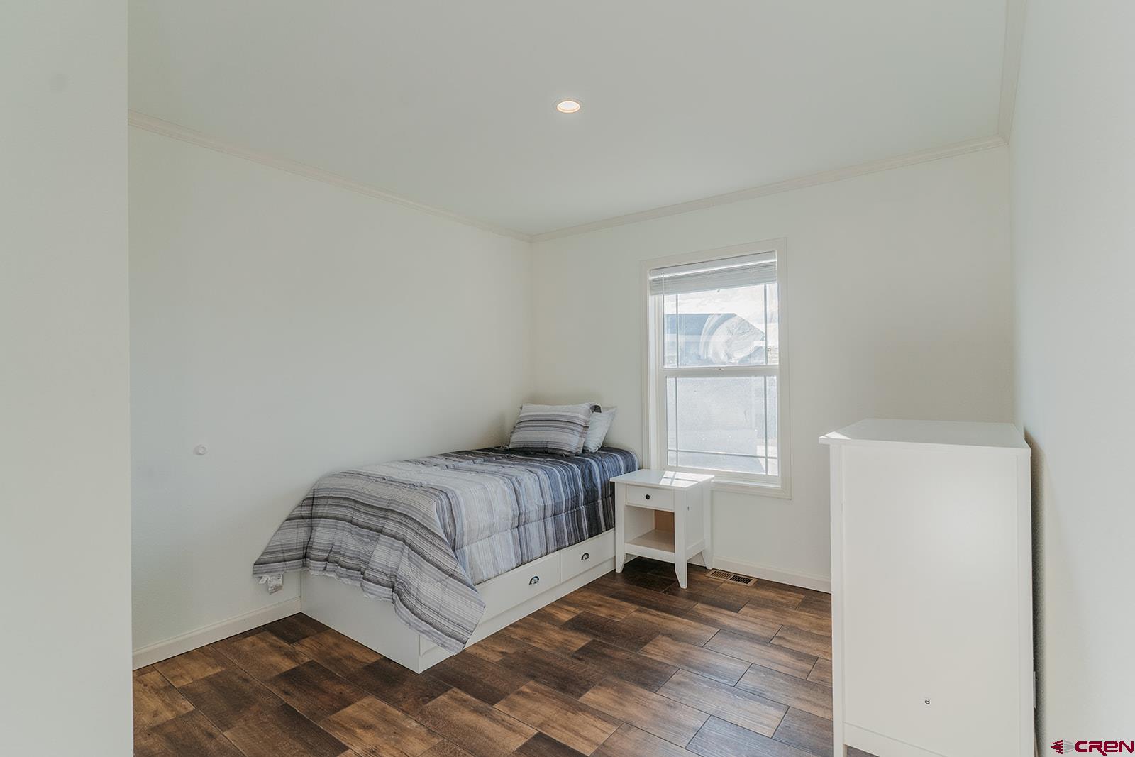 62650 Lasalle Road, Unit 820 Montrose, CO 81403 - Photo 24 of 29 a bedroom with a bed and window