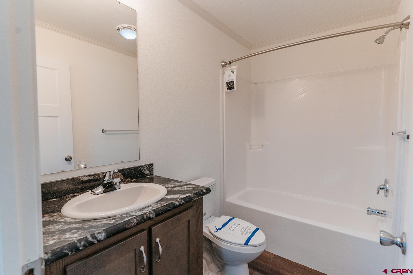 62650 Lasalle Road, Unit 820 Montrose, CO 81403 - Photo 26 of 29 a bathroom with a granite countertop sink toilet and shower