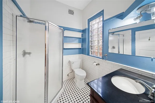 a bathroom with a toilet a sink and shower