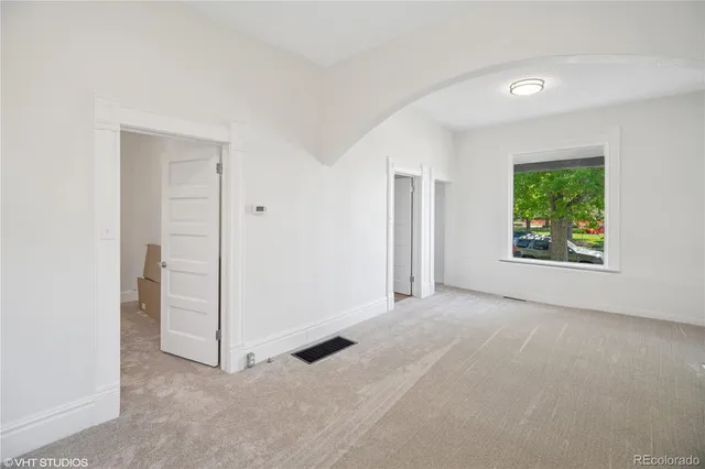 an empty room with windows and closet