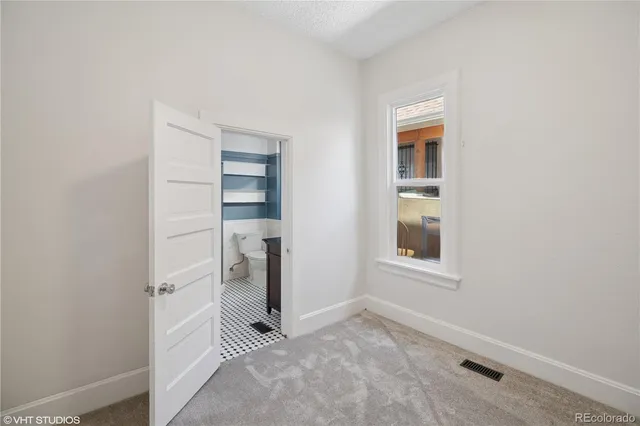 a view of empty room with a closet