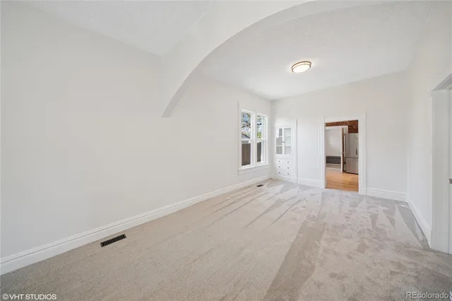 an empty room with windows and closet