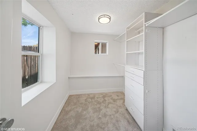 a view of walk in closet with empty racks