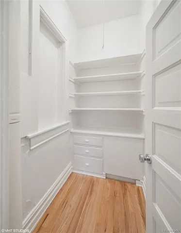 a view of walk in closet with empty racks