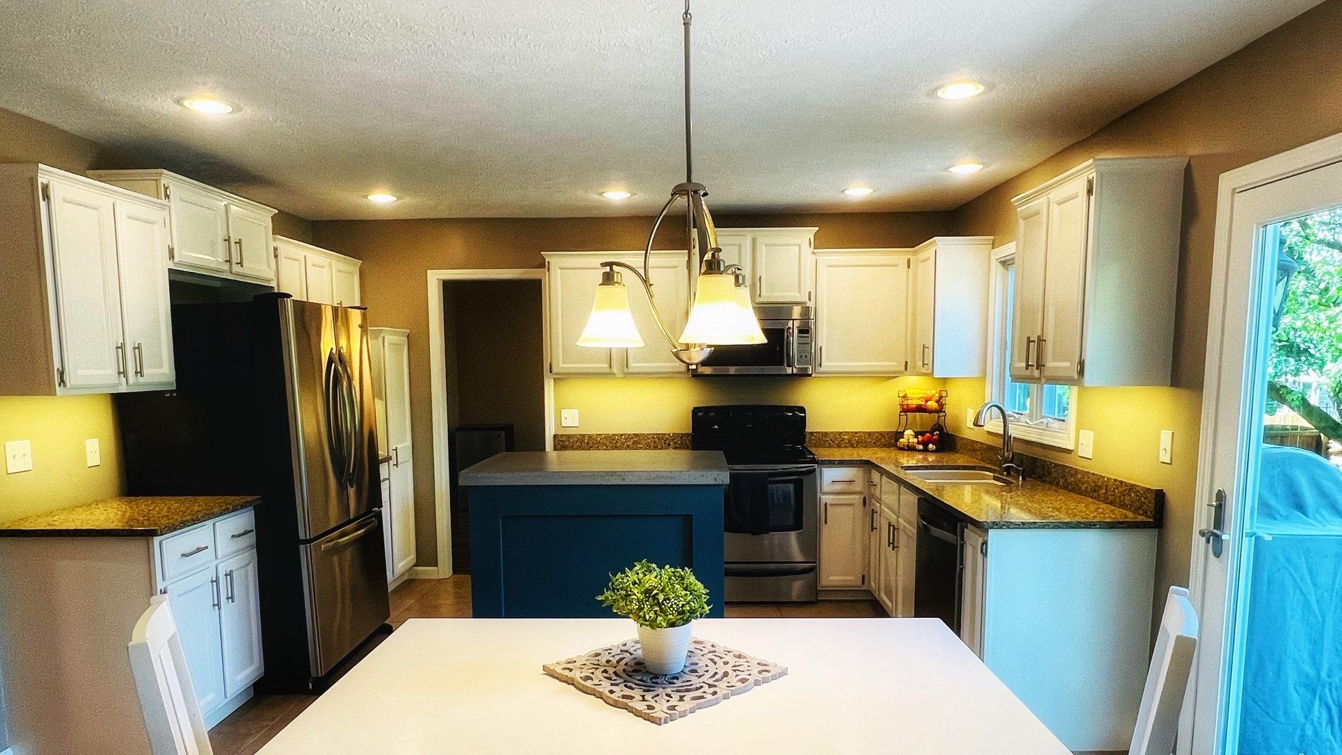 4 Downing Circle Bloomington, IL 61704 - Photo 16 of 69 a kitchen with stainless steel appliances granite countertop a sink a stove a refrigerator a washer dryer and a dining table